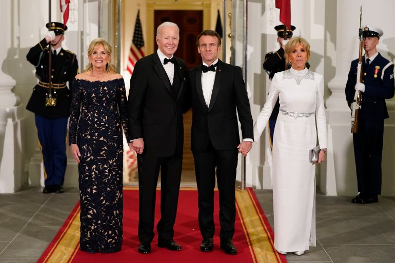 President Joe Biden and first lady Jill Biden pose for photos with French President Emmanuel Macron and his wife Brigitte Macron as they arrive for a State Dinner on the North Portico of the White House in Washington, Thursday, Dec. 1, 2022. (AP Photo/Patrick Semansky)