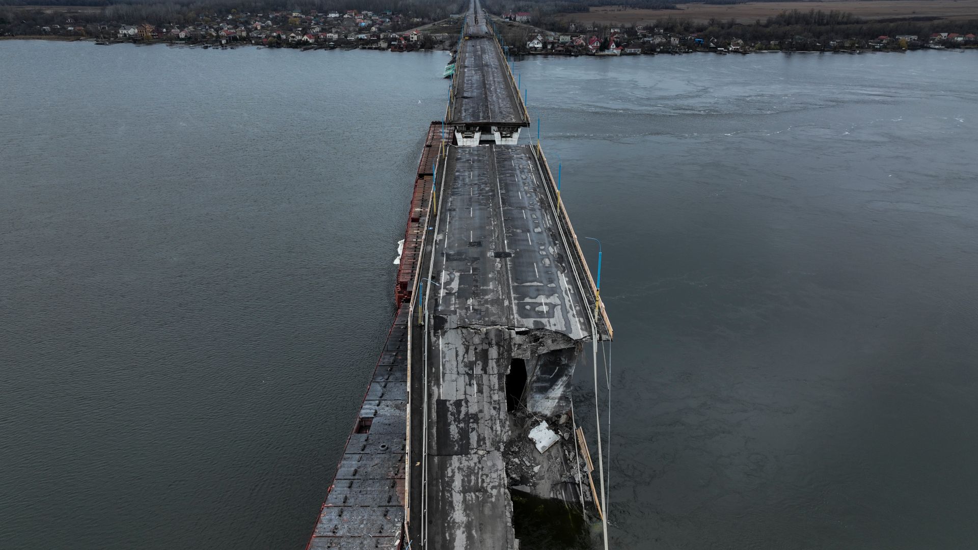The damaged Antonivsky Bridge is visible in Kherson, Ukraine, Sunday, Nov. 27, 2022. The bridge, the main crossing point over the Dnipro river in Kherson, was destroyed by Russian troops in earlier November, after Kremlin's forces withdrew from the southern city. (AP Photo/Bernat Armangue)