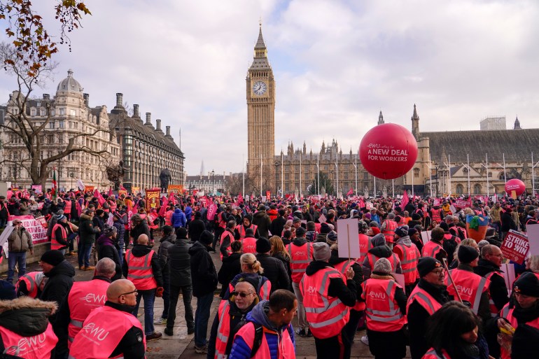 Royal Mail workers gather in Parliament Square, as they hold a protest over pay and jobs, in London, Friday, Dec. 9, 2022. The Communications Workers Union (CWU) has planned six days of strike over pay. (AP Photo/Alberto Pezzali)
