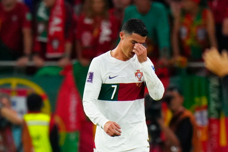 Cristiano Ronaldo brings his hand to his face as he reacts at the end of the match against Morocco.