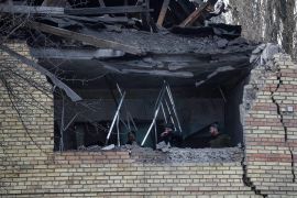 People check a tax office building, that was heavily damaged in Russian shelling, in Kyiv, Ukraine, Dec 14, 2022