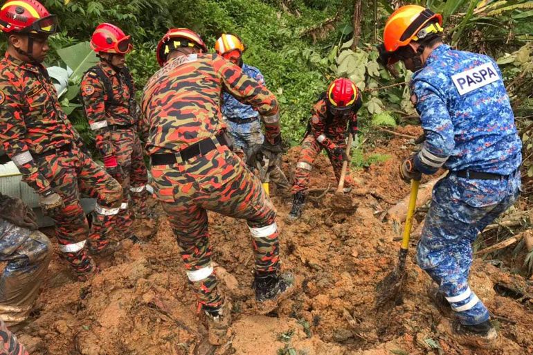 In this photo released by Korporat JBPM, rescuers work during a rescue and evacuation operation following a landslide at a campsite in Batang Kali, Selangor state, on the outskirts of Kuala Lumpur, Malaysia, Dec. 16, 2022. A landslide Friday at a tourist campground in Malaysia left more than a dozen of people dead and authorities said a dozen others were feared buried at the site on an organic farm outside the capital of Kuala Lumpur. (Korporat JBPM via AP)