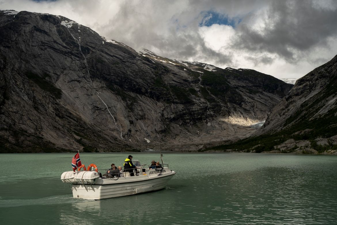 Tourists use a boat to visit the Nigardsbreen glacier