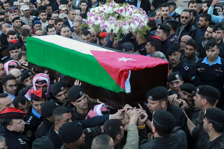 Friends and relatives carry the coffin of Captain Ghaith Al-Rahahleh, a Jordanian police officer who was killed in a shootout during his funeral in Amman, Jordan, Monday, Dec. 19, 2022.