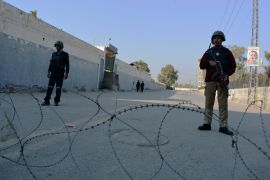 Security officials guard a blocked road leading to a counter-terrorism center