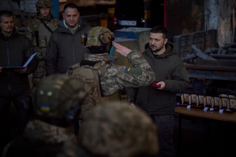 President Zelenskyy awarding soldiers with medals.