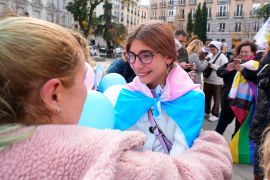 People react outside the parliament after the new Transgender Law was announced in Madrid, Spain