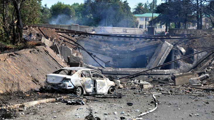 A burned out vehicle marks the spot where a gas tanker exploded under a bridge in Boksburg, east of Johannesburg, South Africa.