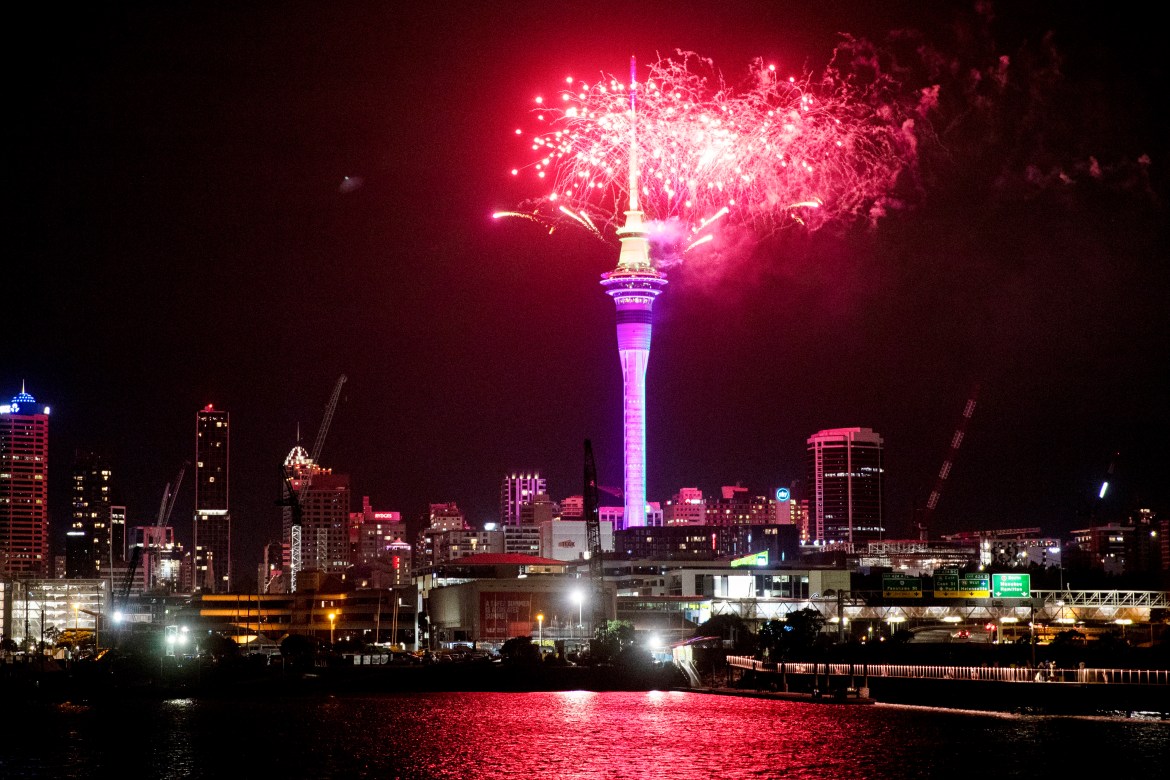 Fireworks explode over Sky Tower in central Auckland as New Year celebrations begin in New Zealand.