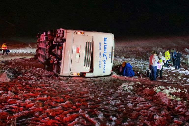 An overturned bus lays in the snow after crashing
