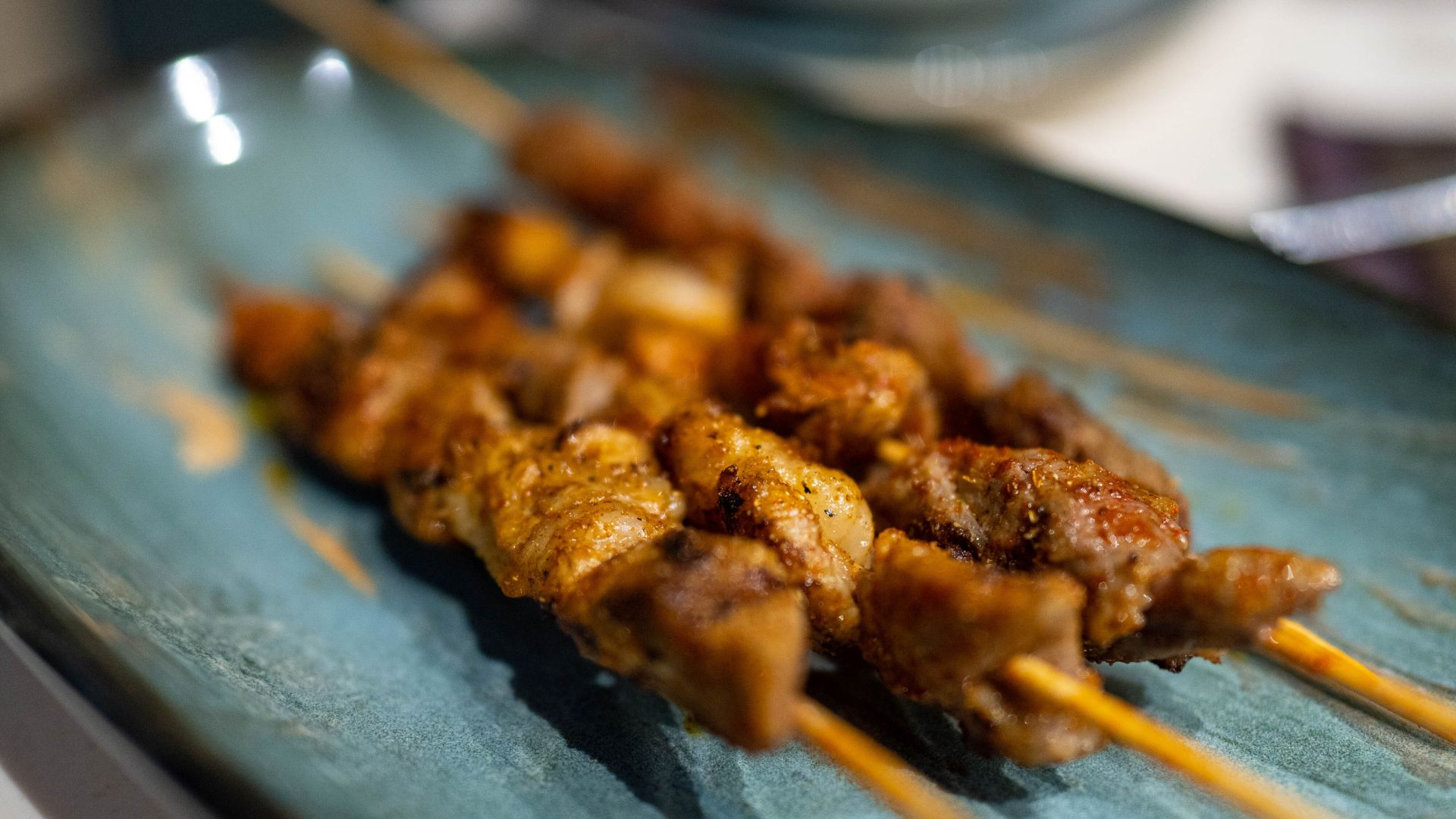 closeup of a skewer of Chinese barbecued lamb