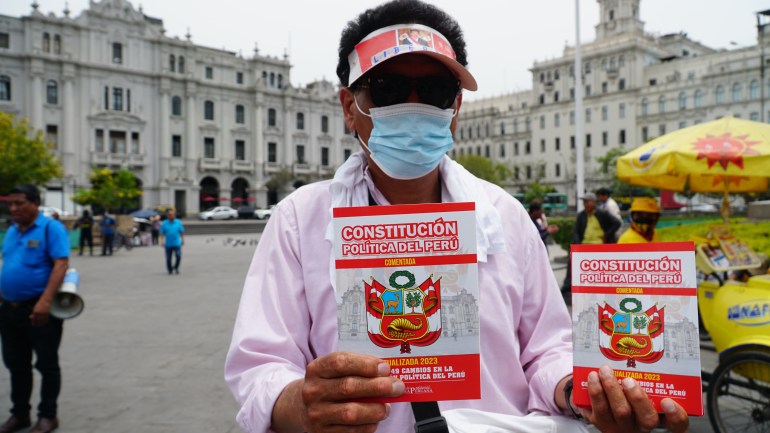Fernandao DaSilva sells copies of Peru’s constitution to protesters and passersby in Lima, Peru