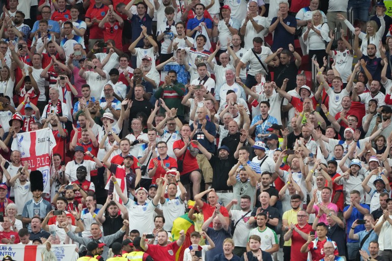 England fans celebrating their victory at Al Bayt Stadium.