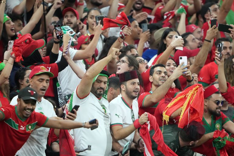 Moroccan fans celebrate 2-1 victory over Canada at Al Thumama Stadium.