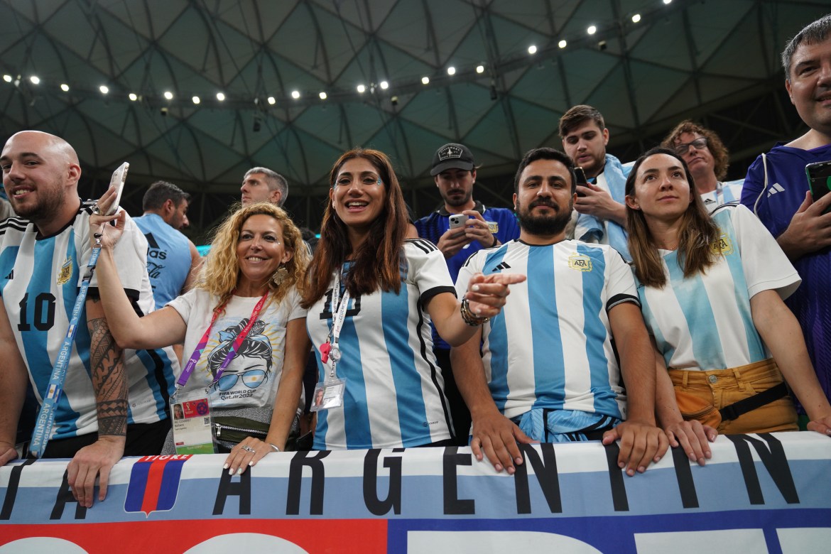 Argentina fans celebrate in the stands before the match.