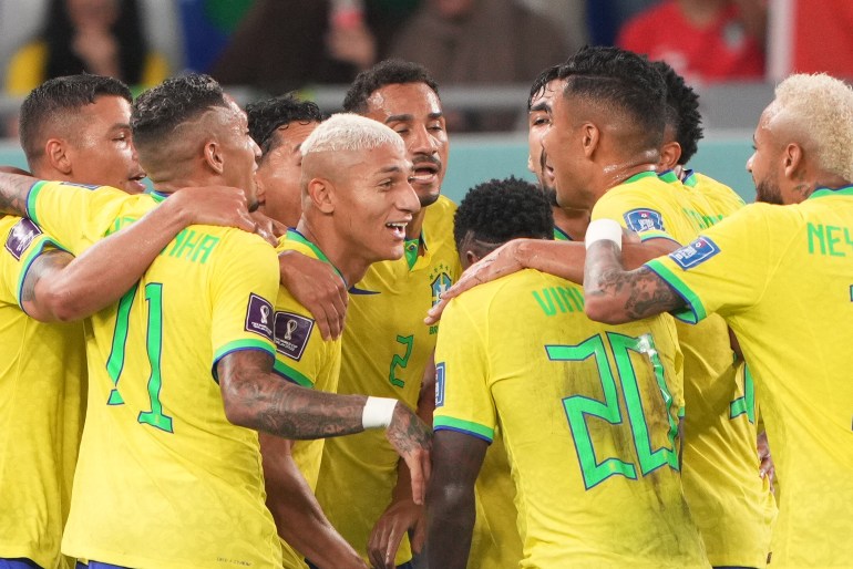Brazil celebrating their third goal, with goalscorer Richarlison in the centre.