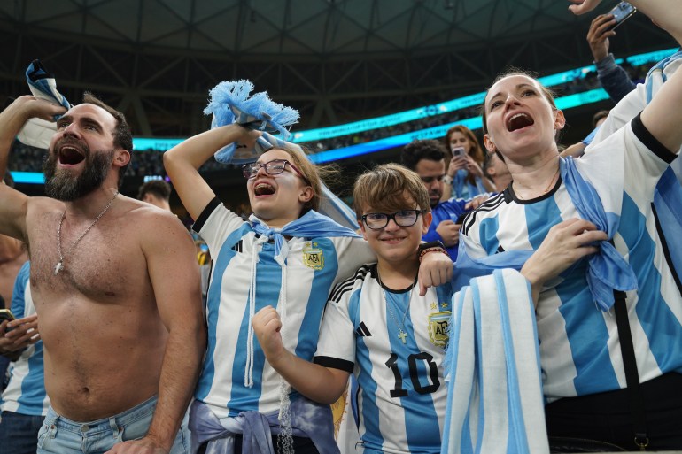 Argentina fans celebrate their side’s win, wearing the blue and white colours and looking happy