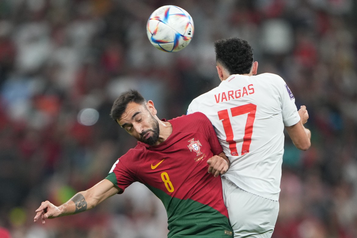 Portugal's Bruno Fernandes in action against Switzerland's Ruben Vargas as they both try to head the ball.