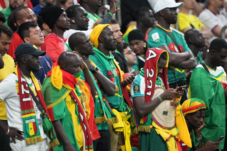 Saddened Senegal fans looking on