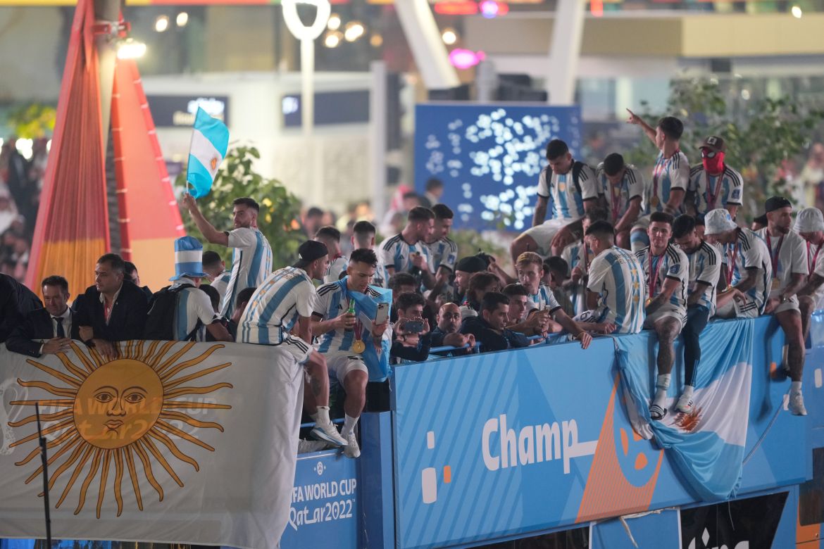Argentinian players sitting atop a bus after their victory