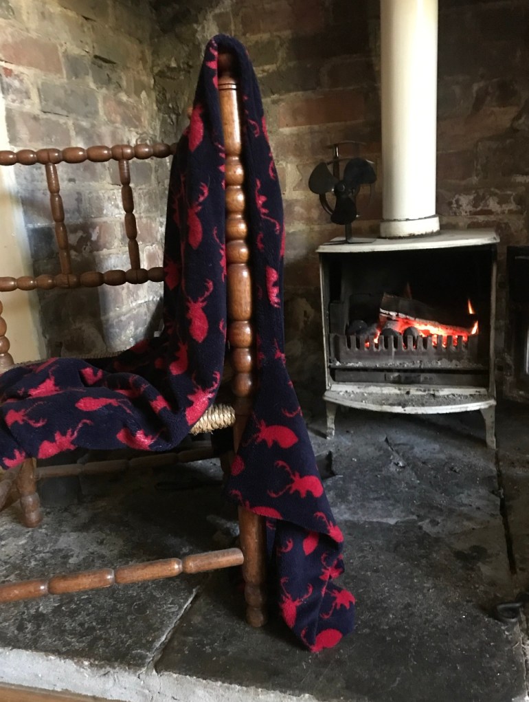 An item of clothes next to a fireplace