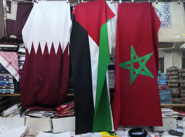 The Moroccan flag hangs next to the Qatar and Palestine flags in Souq Waqif, Doha