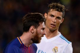 Real Madrid's Portuguese forward Cristiano Ronaldo (R) looks at Barcelona's Argentinian forward Lionel Messi during the Spanish league football match between FC Barcelona and Real Madrid CF at the Camp Nou stadium in Barcelona on May 6, 2018.