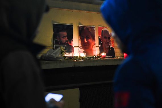 Tribute candles and pictures of three Kurds shot in Paris in December 2022.