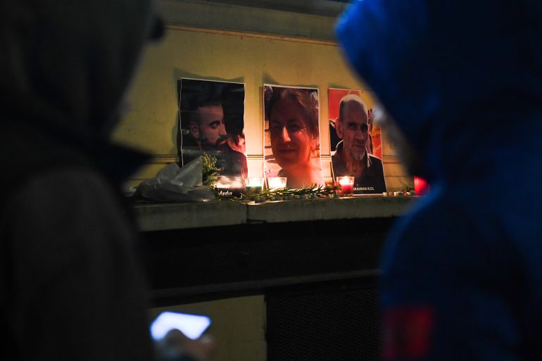 Tribute candles and pictures of three Kurds shot in Paris in December 2022.