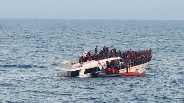 A handout photo provided by the Lebanese Army on December 31, 2022, shows a sinking migrant boat in Mediterranean waters, off the country's northern coast near Tripoli during a rescue operation by the Lebanese navy. - Two migrants, including a child, died when their makeshift boat sank, a security source said, while Lebanon's army said the navy saved 200 people from the stricken vessel off the northern coast. (Photo by Lebanese Army Website / AFP) / RESTRICTED TO EDITORIAL USE - MANDATORY CREDIT "AFP PHOTO / LEBANESE ARMY WEBSITE" - NO MARKETING - NO ADVERTISING CAMPAIGNS - DISTRIBUTED AS A SERVICE TO CLIENTS
