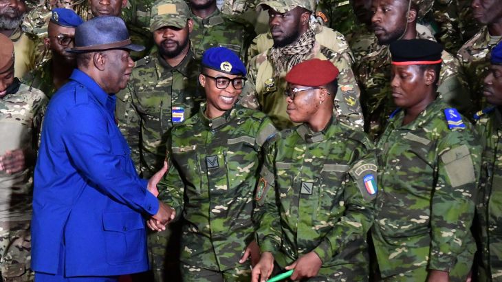 Ivorian President Alassane Ouattara speaks with some of the 46 Ivorian soldiers who were arrested in Mali in July.