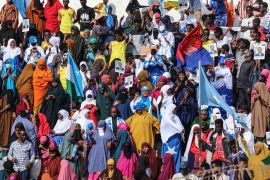 Demonstrators hold flags during a rally against the Al-Shabab group in Mogadishu