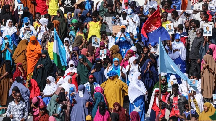 Demonstrators hold flags during a rally against the Al-Shabab group in Mogadishu