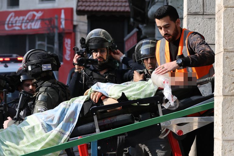Israeli forces film as paramedics wheel out of a building Palestinian man reportedly shot by Israeli security forces after he tried to make an attack against a soldier