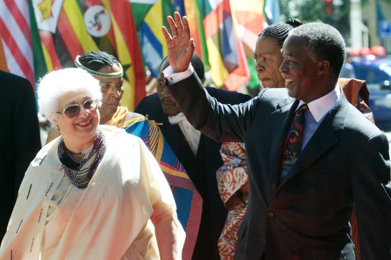 President Thabo Mbeki, accompanied by Parliamentary Speaker Frene Ginwala, waves to crowds.