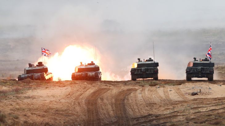 A British Army Challenger 2 tank fires during a NATO exercise in Adazi, Latvia.