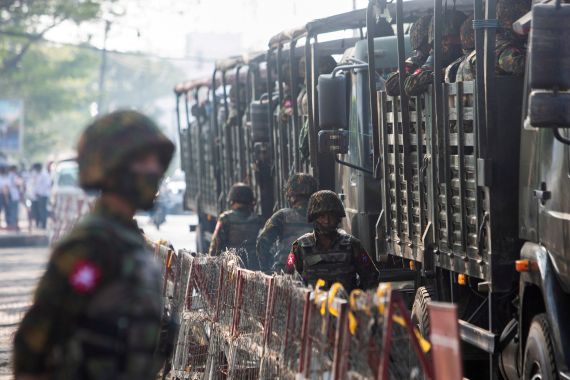 Soldiers stand next to military vehicles in Yangon, Myanmar, February 15, 2021
