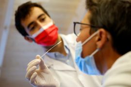 A medical worker administers a nasal swab to a patient at a coronavirus disease (COVID-19) testing centre in Nantes, near Nantes, France
