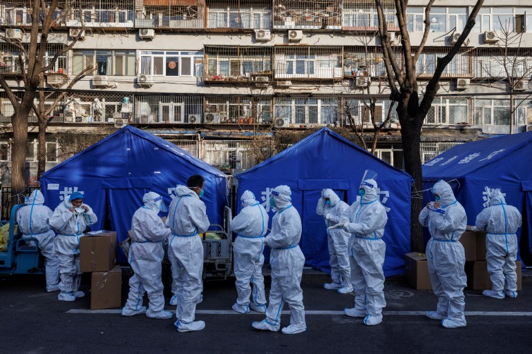 Pandemic prevention workers gather before their shift to look after buildings where residents do home quarantine in Beijing