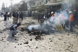 Police officers collect evidences at the site of a suicide car bombing in Islamabad, Pakistan December 23, 2022.