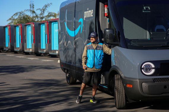 Driver David Gonzalez prepares to head out on his route in an electric Rivian truck at the Amazon facility in Poway, California
