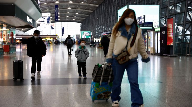 Travellers walk with their luggage at Chengdu Shuangliu International Airport in Chengdu, Sichuan province, China