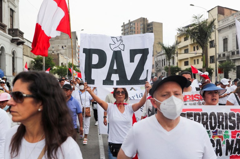 People march during a rally for peace in Lima, Peru