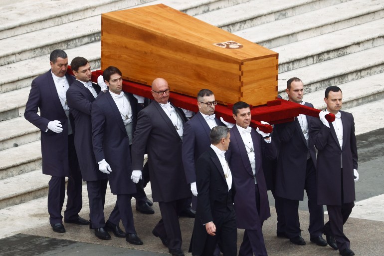 The coffin of former Pope Benedict is carried during his funeral, in St. Peter's Square at the Vatican, January 5, 2023. REUTERS/Guglielmo Mangiapane
