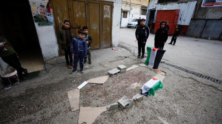 Children stand next to the site where a 16-year-old Palestinian was killed by the Israeli army int he West Bank.