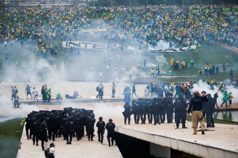 Supporters of Brazil's former President Jair Bolsonaro demonstrate against President Luiz Inacio Lula da Silva while security forces operate, outside Brazil’s National Congress in Brasilia