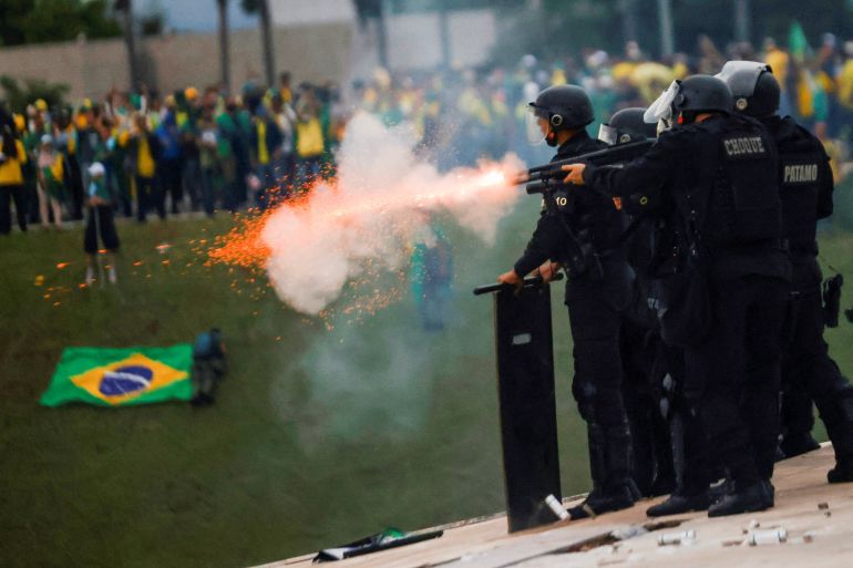 Security forces fire a weapon during protests in Brasilia on January 8, 2023.