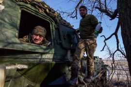 Ukrainian service members look on from a 2S3 Akatsiya self-propelled howitzer at their position in a front line in Donetsk region, Ukraine.