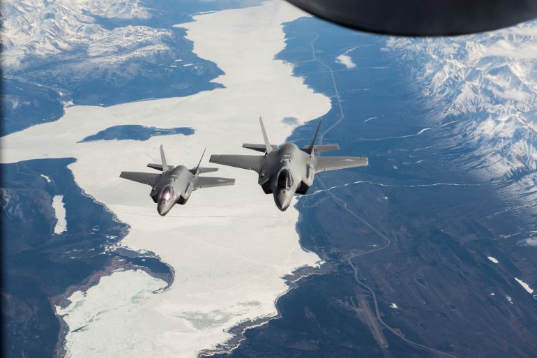 Two US Air Force F-35A Lightning II fighter aircraft fly over the Alaska-Canada Highway