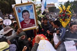 People react near the coffin of a man killed in clashes with Peru security forces